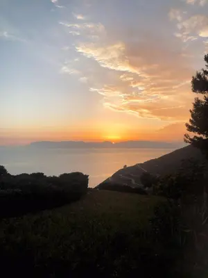 a sunset over the water with the sun in the sky at Casa di Cri in San Vito lo Capo