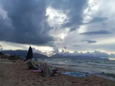 a group of people on a beach with the ocean at casa Barone in Balestrate
