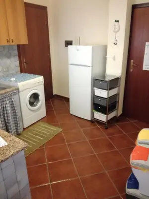 a kitchen with a refrigerator and a washing machine at casa Barone in Balestrate