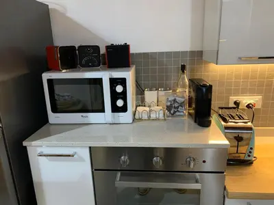 a microwave sitting on top of a kitchen counter at Casa del Contrabbasso in Palermo