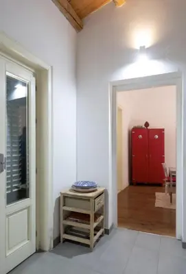 an empty room with a red cabinet and a door at Casa del Contrabbasso in Palermo