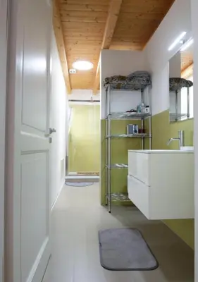 a bathroom with a sink and a mirror and a door at Casa del Contrabbasso in Palermo
