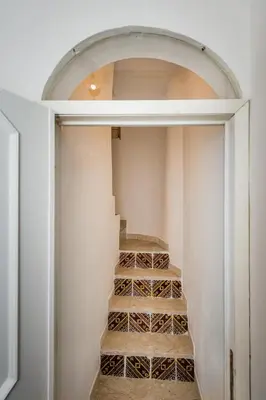 a room with a staircase with wine glasses in it at Le Maioliche in Castellammare del Golfo