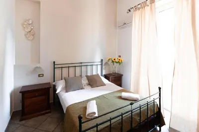 a bedroom with a bed and a window at Hotel Concordia in Palermo