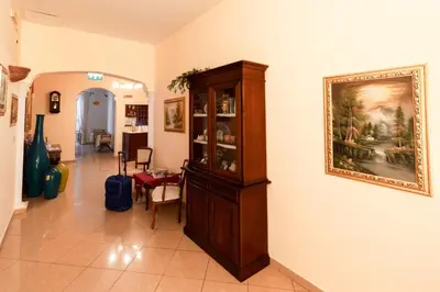 a living room with a large wooden cabinet on the wall at Hotel Concordia in Palermo