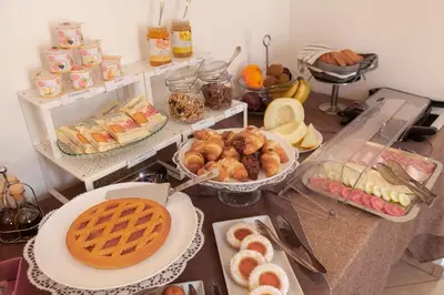 a table topped with lots of different types of food at Hotel Concordia in Palermo