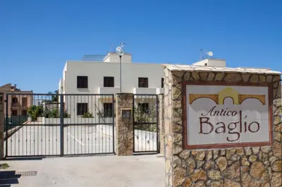 a sign on a gate in front of a building at Case vacanza Cristina site in Antico Baglio e in via Abruzzi n 161 in San Vito lo Capo