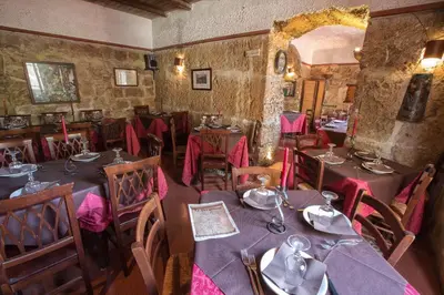 a restaurant with tables and chairs in a room at Vittorio Emanuele Appartamenti in Palermo