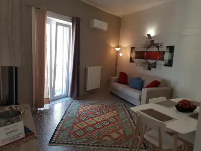a living room with a couch and a table at Vittorio Emanuele Appartamenti in Palermo