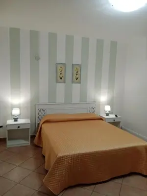 a bedroom with a bed and two night stands at Appartamentino Cinisi in Cinisi