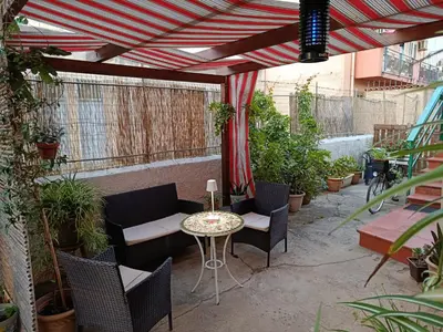 a patio with a table and chairs and plants at Appartamentino Cinisi in Cinisi