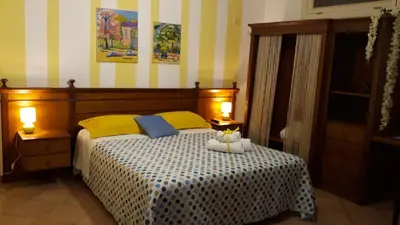a bedroom with a bed with two lamps on it at Appartamentino Cinisi in Cinisi