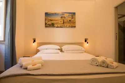 a bedroom with two beds with towels on them at Sammartino suite in Palermo