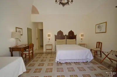 a bedroom with a bed and a table and chairs at B&B Casa Ruffino in Balestrate