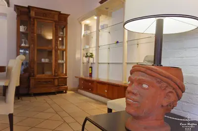 a lamp on a table with a bust of a head at B&B Casa Ruffino in Balestrate