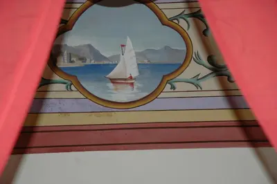 a painting of a sail boat in a mirror at B&B Casa Ruffino in Balestrate