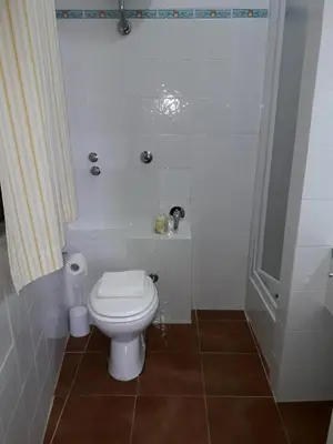 a bathroom with a white toilet and a shower at Le Tre Caravelle in Trabia