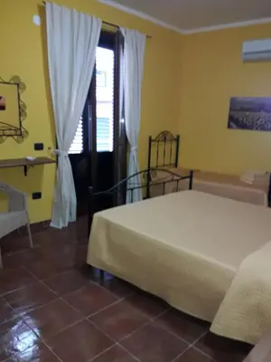a bedroom with a bed and a window at Le Tre Caravelle in Trabia