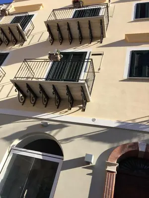 a building with balconies on the side of it at Ai Gradini Affittacamere in Castellammare del Golfo