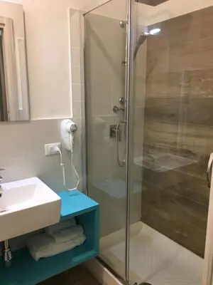 a bathroom with a glass shower and a sink at Ai Gradini Affittacamere in Castellammare del Golfo