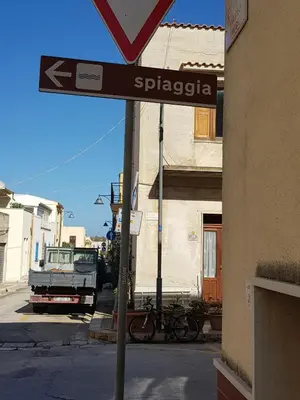 a street sign on the corner of a street at Bilocale Mini Very in San Vito lo Capo