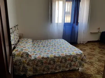 a bedroom with a bed with a quilt on it at Bilocale Mini Very in San Vito lo Capo