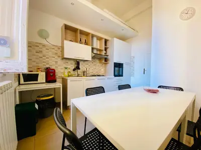 a kitchen with a white table and chairs at Liolà Home #Teatro Massimo in Palermo