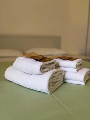 a pile of towels sitting on top of a table at Liolà Home #Teatro Massimo in Palermo