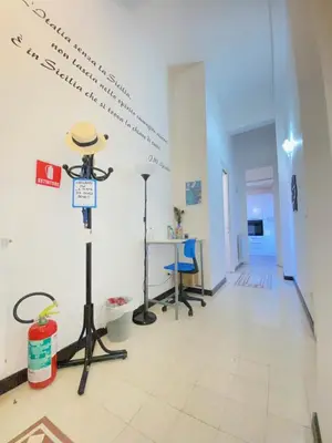 a hallway with a room with writing on the wall at Liolà Home #Teatro Massimo in Palermo