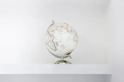 a globe on a stand on a white background at Suite Palermo Apartment in Palermo
