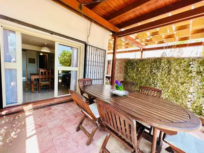 a wooden table and chairs on a patio at Villino Addaura in Lido di Mondello