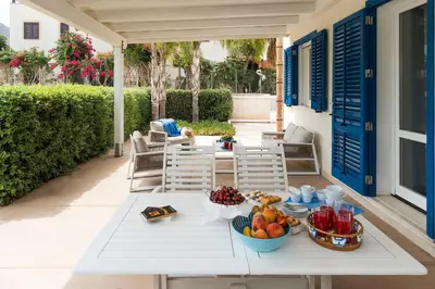 a table with bowls of fruit on a patio at Spuma di Mare - Riccio in San Vito lo Capo