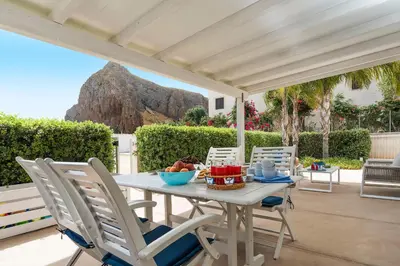a table with a bowl of fruit on a patio at Spuma di Mare - Riccio in San Vito lo Capo