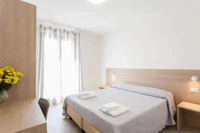 a bedroom with a bed with two towels on it at Case Vacanza appartamenti Trinacria in San Vito lo Capo