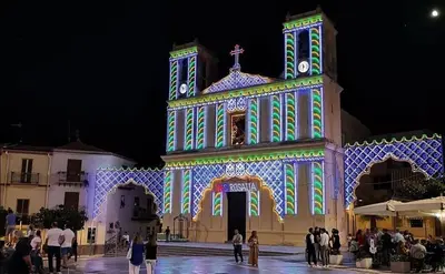 a large building with lights on it at night at L'angolo di Rosa in Campofelice di Roccella