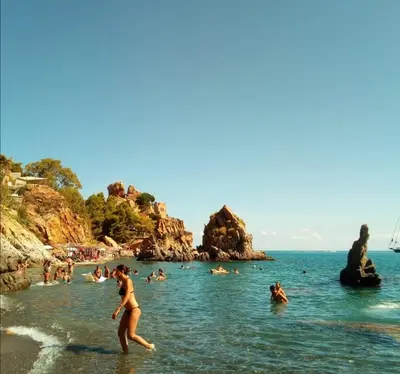 a woman playing in the water at a beach at L'angolo di Rosa in Campofelice di Roccella