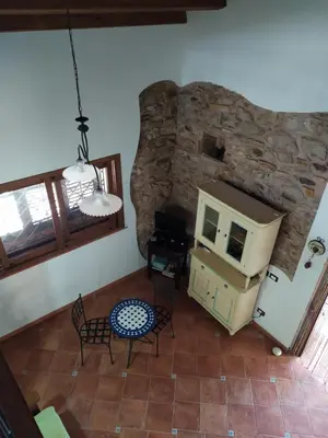 an overhead view of a living room with a stone wall at Antico Rustico in Scopello