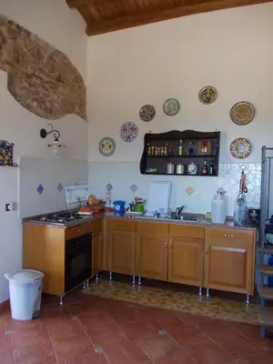 a kitchen with a sink and a stove top oven at Antico Rustico in Scopello