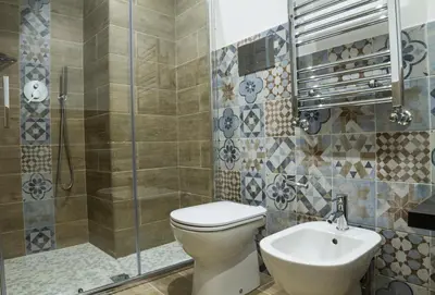 a bathroom with a toilet and a sink and a shower at Bagnasco 18 suite&terrace in Palermo