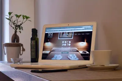 a laptop computer sitting on top of a table with a cup at Bagnasco 18 suite&terrace in Palermo