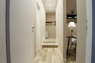 a hallway with a stairway with a table and a lamp at Bagnasco 18 suite&terrace in Palermo