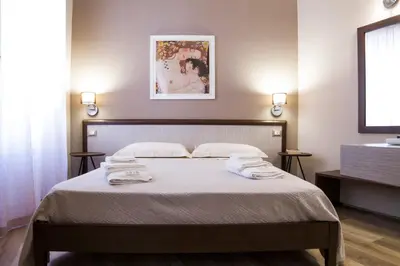 a bedroom with a bed with towels on it at Bagnasco 18 suite&terrace in Palermo