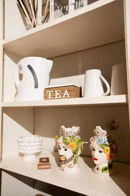 a shelf with cups and tea items on it at Montesanto 13 in Palermo