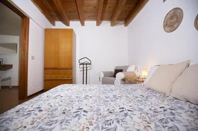 a bedroom with a bed and a living room at Montesanto 13 in Palermo
