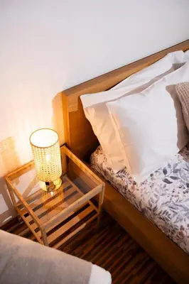 a bedroom with a bed with a table with a pillow at Montesanto 13 in Palermo