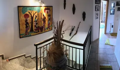 a staircase with a painting on the wall at Stunning Sicilian Villa in Carini