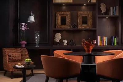 a dining room with orange chairs and a table at NH Collection Palermo Palazzo Sitano in Palermo
