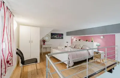 a bedroom with a large bed with a pink wall at La casa di Anita nel cuore di Segesta in Calatafimi