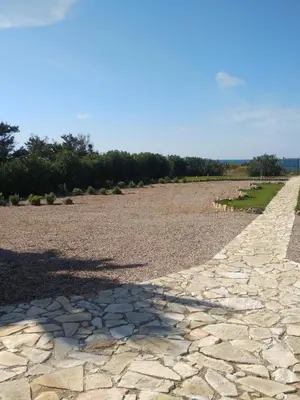 a cobblestone road in a field at Mansarda Camelie via dei Normanni, 45 in Campofelice di Roccella