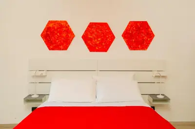 a bedroom with a red bed and four red lamps at Casa Relax Mondello in Mondello